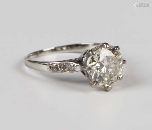 A diamond ring, claw set with the principal circular cut dia...