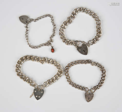 Four silver curblink bracelets, each with a silver heart sha...