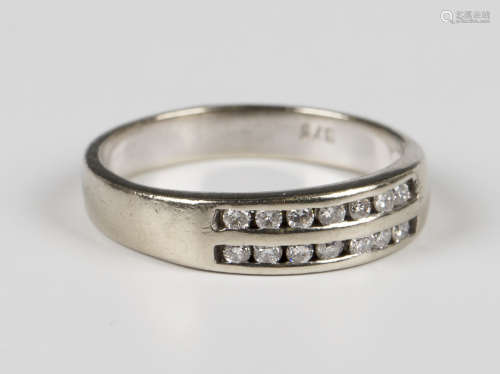 A 9ct white gold ring, mounted with two rows of seven circul...