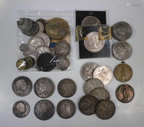 A collection of British coins and medallions, including a Ge...
