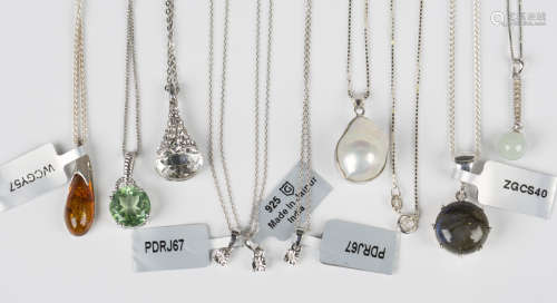 Three silver and diamond single stone pendants, each length ...