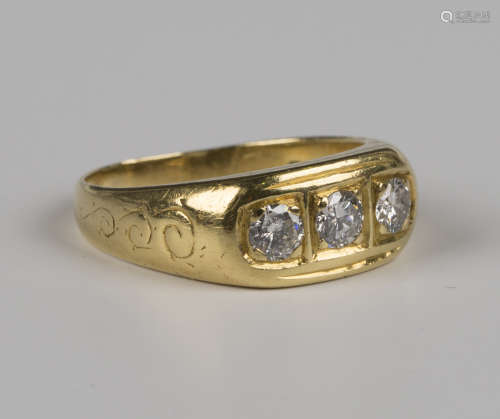 An 18ct gold and diamond three stone ring, mounted with circ...