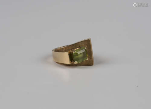 A gold ring of abstract design, mounted with a cut cornered ...