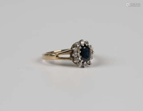 A 9ct gold, sapphire and diamond oval cluster ring, claw set...