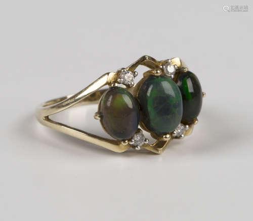 A 9ct gold ring, mounted with three oval cabochon dark opals...
