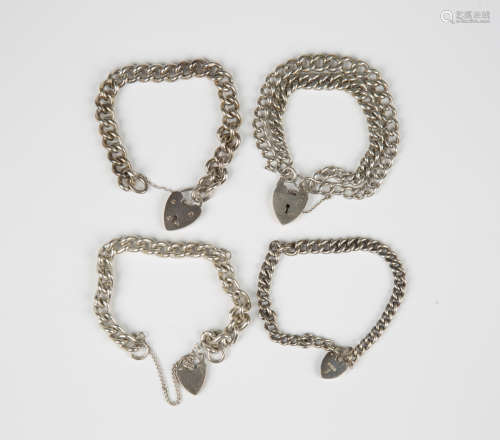 Three silver curblink bracelets, each with a silver heart sh...