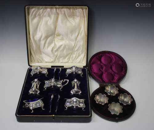 An Edwardian silver seven-piece condiment set of cushion for...