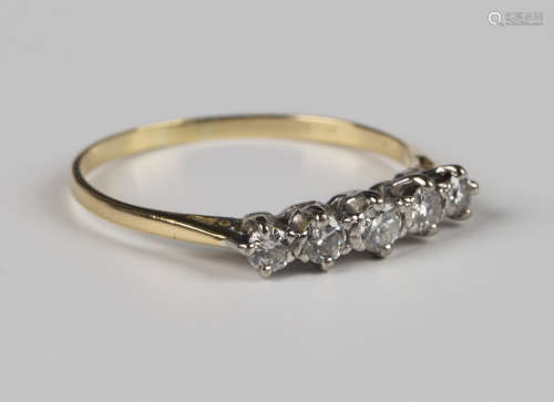 A gold and diamond five stone ring, mounted with a row of gr...
