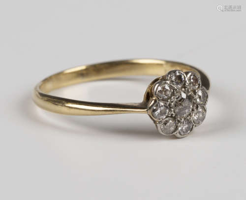 A gold and diamond nine stone cluster ring, mounted with the...