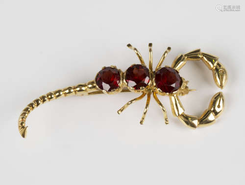 A gold and garnet brooch, designed as a scorpion, mounted wi...