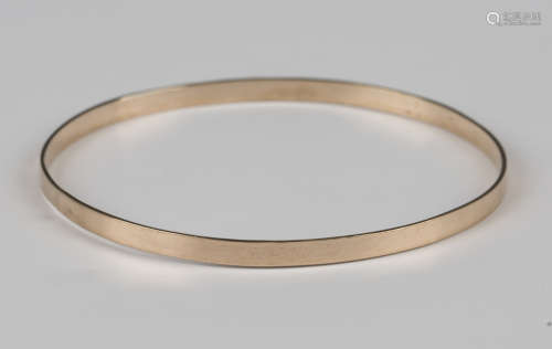 A gold circular bangle, detailed '9ct', weight 6.7g, inside ...