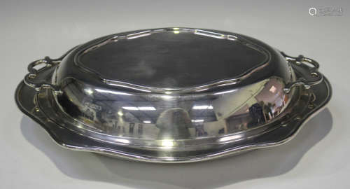 A George V silver oval entrée dish and two-handled cover wit...