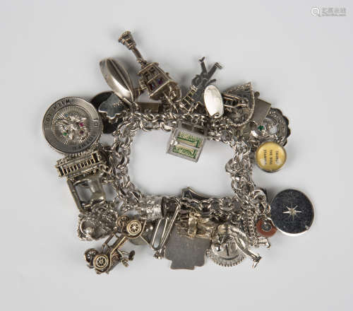 A multiple link charm bracelet, fitted with a variety of cha...