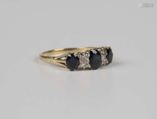 An 18ct gold, sapphire and diamond ring, claw set with three...