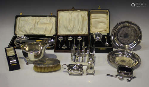 A group of silver items, including a George V sauceboat with...