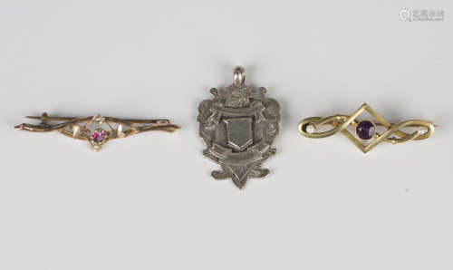 A gold bar brooch, collet set with a circular cut amethyst b...