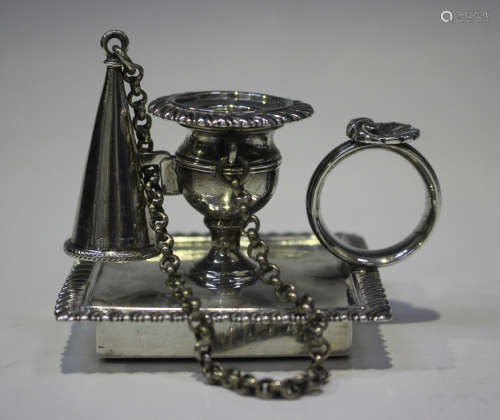 A George IV silver chamberstick and snuffer with urn shaped ...