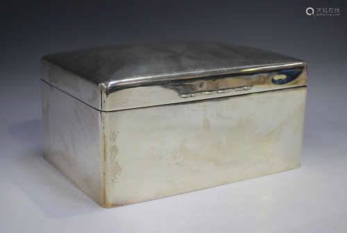 A George V silver rectangular cigar box with domed hinged li...