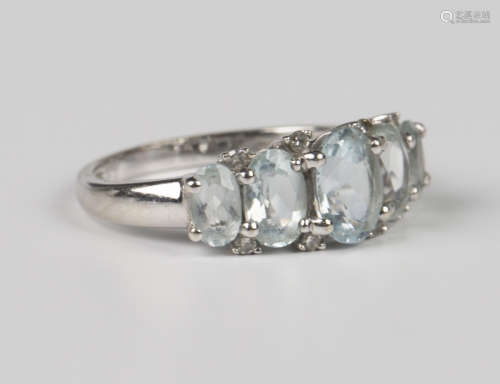 A 9ct white gold, aquamarine and diamond ring, mounted with ...