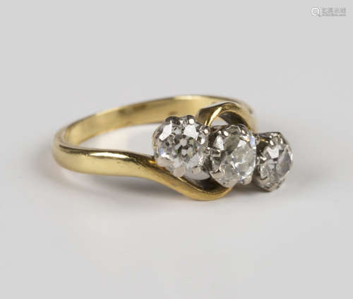 An 18ct gold and diamond three stone ring, claw set with a r...