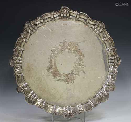 A late Victorian silver circular salver with raised 'C' scro...