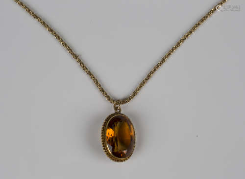 A gold pendant, collet set with an oval cut citrine within a...
