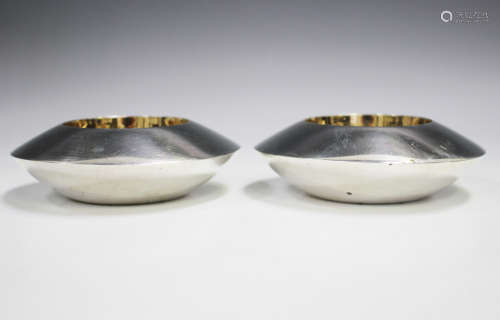 A pair of Elizabeth II silver circular salts, each of disc f...