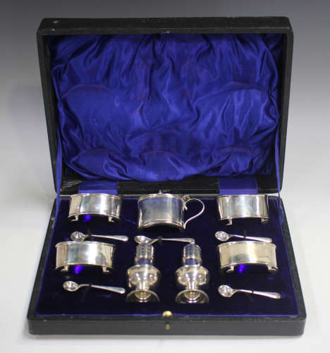 A George V silver seven-piece condiment set of oval form, co...