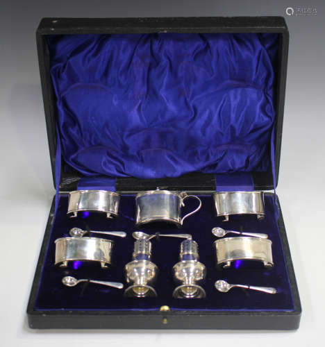 A George V silver seven-piece condiment set of oval form, co...