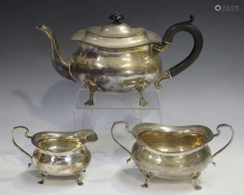 A George V silver three-piece tea set of cushion form, raise...