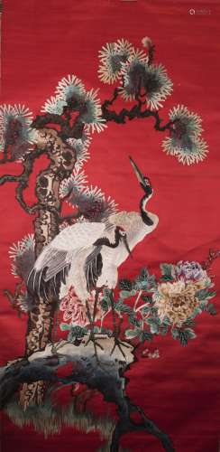 A CHINESE RED-GROUND EMBROIDERED CRANE SILK HANGING