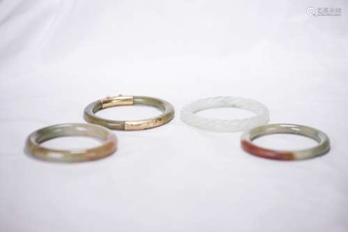 A GROUP OF FOUR JADE BANGLES
