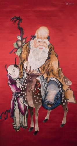 A CHINESE RED-GROUND EMBROIDERED LONGEVITY GOD AND