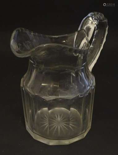 A large 19thC glass water jug , decorated with fluted