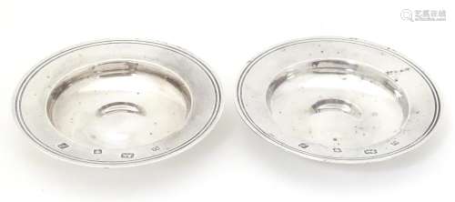 A pair of silver dishes modelled as miniature Armada