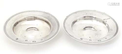 A pair of silver dishes modelled as miniature Armada