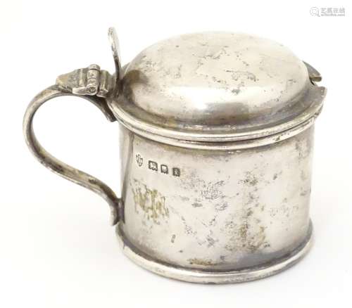 A silver mustard pot with blue glass liner, hallmarked