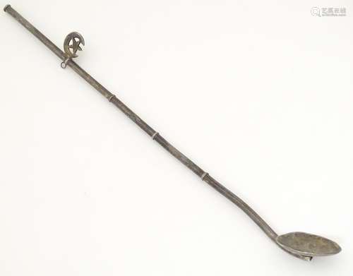 A white metal long handled mixing spoon / straw with