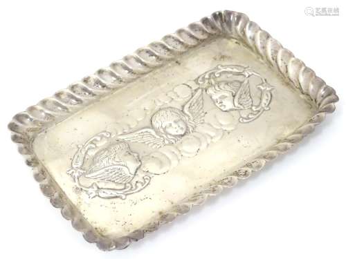 A silver dressing table tray with embossed angel