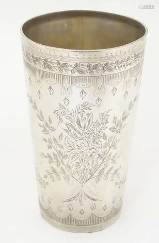 A Victorian silver beaker with engraved decoration,