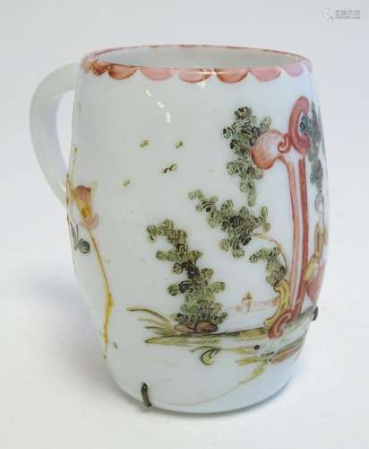 An 18thC milk glass mug with hand painted decoration.