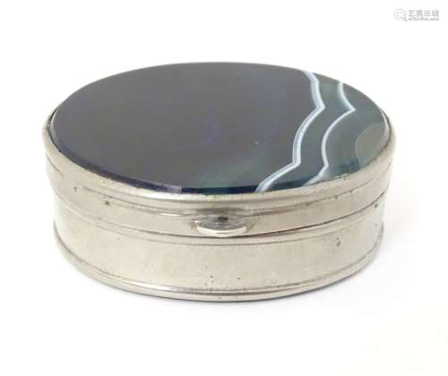 A silver plate pill box of oval form set with blue