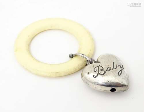 A silver rattle / teether with heart detail, hallmarked