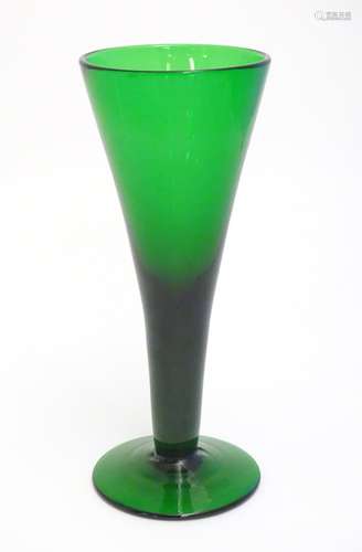 A studio green glass vase of conical form with pedestal