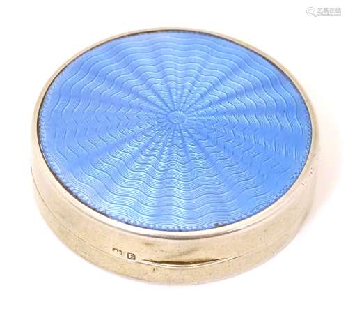 An Art Deco silver compact with blue guilloche enamel