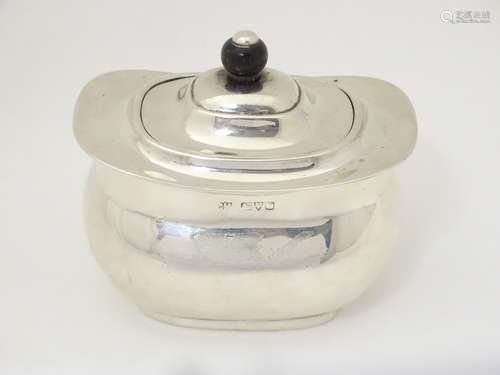 A silver caddy with hinged lid hallmarked Chester 1911,