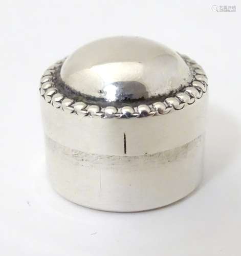 A white metal pill box approx 3/4