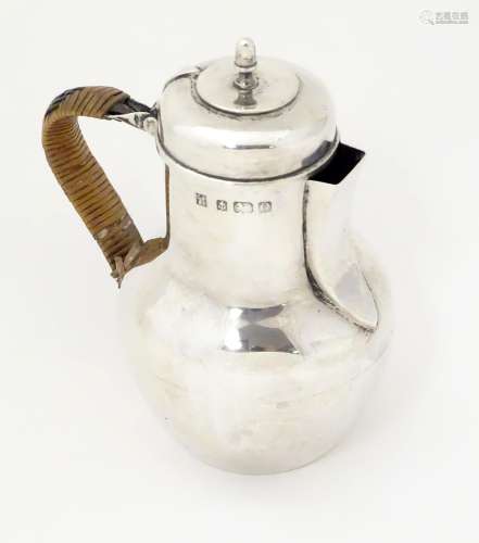 An Edwardian silver hot water jug formed as a Channel