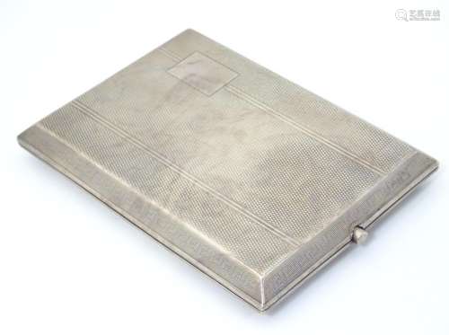 An Art Deco silver cigarette case with engine turned