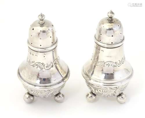 A pair of silver pepperettes, hallmarked Birmingham
